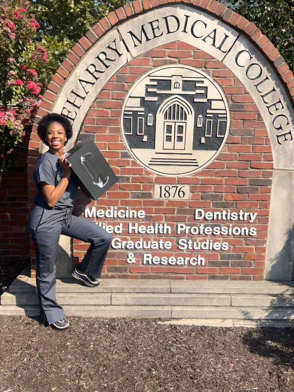Jada in scrubs at the dental school entrance